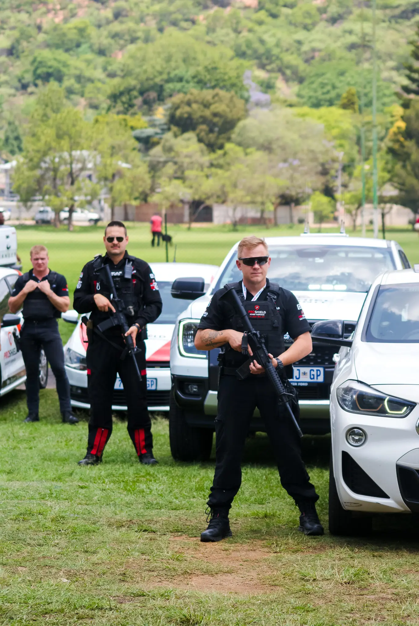 Proshield Security guards standing besides their security cars in Pretoria.
